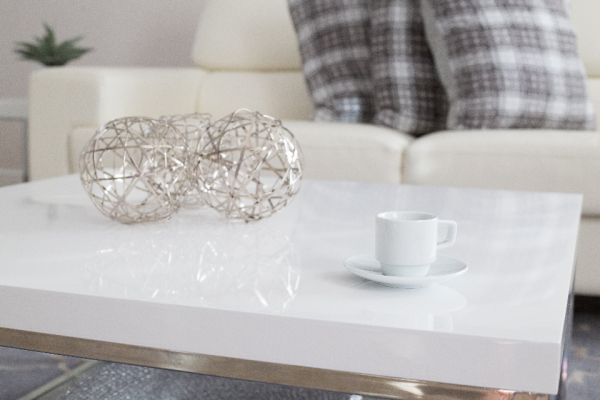 A white coffee cup on a low white table in a bright living room