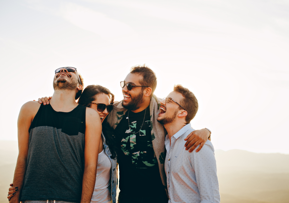 A group of friends laughing together outdoors
